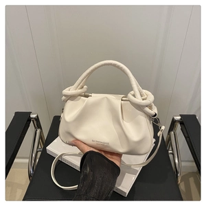 Detail of off-white ruched leather handbag with circular handle and elegant brand logo