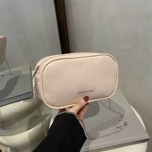 Chic beige PU leather makeup bag with chain strap and elegant metallic zipper closure