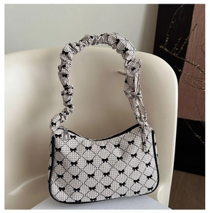 Detail of checkered fabric underarm bag with black bow lattice and pleated handle