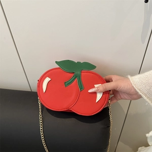 Creative cherry shaped shoulder bag with red PU body and green leaf handle decoration