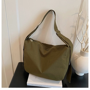 Detail view of olive green waterproof nylon bucket bag with adjustable silver buckle strap