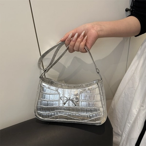 Silver crocodile embossed rectangular handbag with a metallic bow on the front