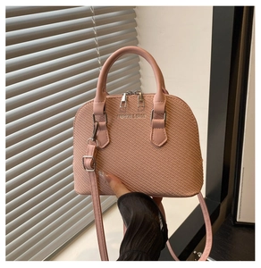 Close-up of pink shell-shaped bag with woven texture and Fashion & Bags text