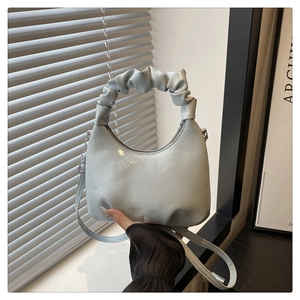 Detail of light blue pleated bucket bag showing the texture and Fashion Bags logo