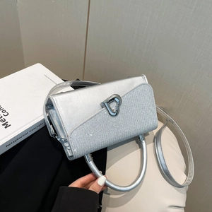Silver glossy crossbody bag with heart-shaped metal lock and glitter splicing detail
