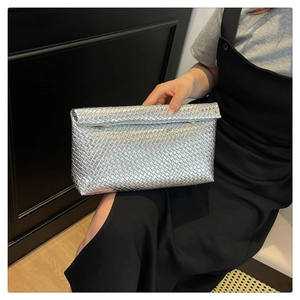 Macro shot of silver woven texture and metallic finish on the rectangular envelope clutch
