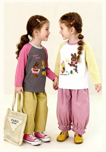 Detail of kids raglan sleeve T-shirts with cartoon prints and colorful patchwork design