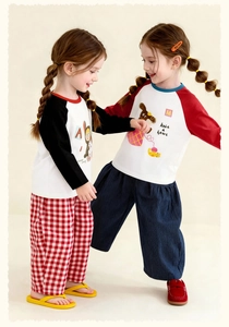 Detail view of kids cotton cartoon loungewear with raglan sleeves and patterned pants