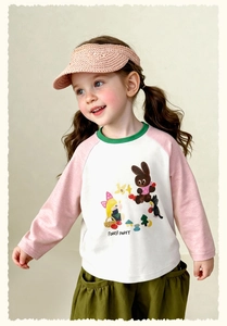 Detailed view of forest party cartoon print on children's pink and green raglan tee