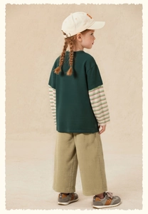 Detail of kids faux two-piece t-shirt with striped sleeves and corduroy wide-leg pants
