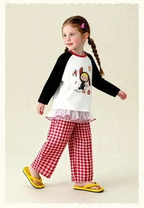 Detail of kids cartoon raglan sleeve top with mesh hem and red plaid wide-leg trousers