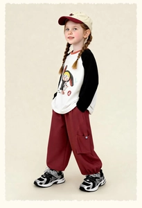 Close-up of kids' cartoon long-sleeve T-shirt with contrasting raglan sleeves and embroidery