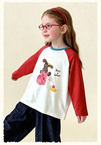 Detail of girls' raglan sleeve tee with red sleeves and cute cartoon rabbit print