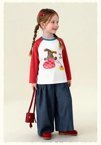 Detail of girl's raglan sleeve T-shirt with dog print and blue striped wide-leg pants
