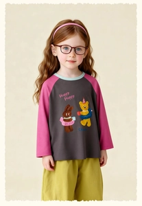 Detailed view of kids' raglan sleeve top with cartoon bear print and olive green pants