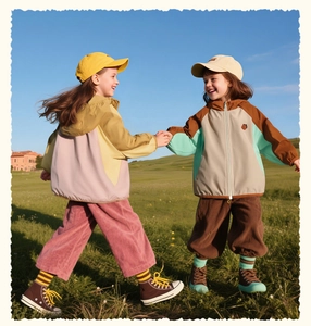 Outdoor color-block hooded jackets for children shown on kids in a nature park setting