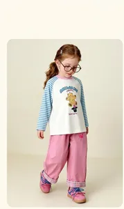 Close-up of pink girls' wide-leg trousers with checkered cuff details and logo print