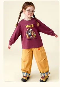 Detail of children's cartoon Felix the Cat print on cotton sweatshirt and yellow pants