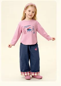 Detail of girls' pink long sleeve T-shirt and navy trousers with plaid cuffs