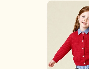 Close-up of red cable knit girls cardigan with white buttons and blue plaid shirt collar