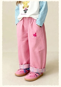 Detail of pink kids casual trousers featuring cute rabbit embroidery and plaid cuffs