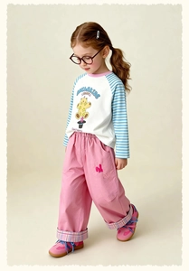 Detail of pink cargo pants with cute bunny embroidery and plaid cuff accents for girls