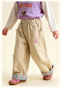Detail of khaki kids pants featuring cute rabbit embroidery and plaid cuff lining