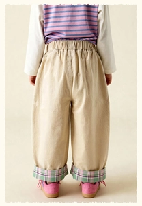 Rear view of kids loose-fit khaki trousers with elastic waist and rolled-up checkered hem