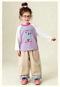 Detailed view of kids' cartoon striped shirt and wide-leg trousers with rabbit embroidery
