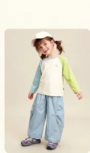 Detail view of kids casual outfit featuring a logo raglan tee and light blue wide-leg pants