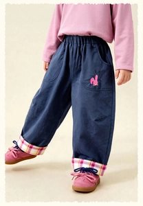 Detail of navy kids trousers featuring pink rabbit embroidery and checkered lining hem
