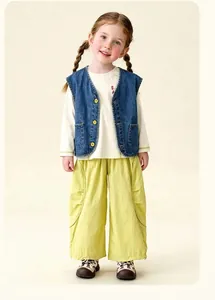 Detail of children's denim vest, white long sleeve tee, and bright wide-leg casual pants