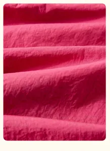 Close-up of vibrant pink breathable woven fabric texture on children wide-leg pants