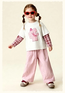Detail of kids pink wide-leg trousers and layered elephant print t-shirt outfit