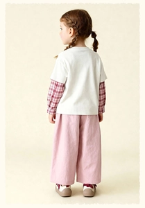 Back view of girl in layered plaid shirt and pink wide-leg cotton pants outfit