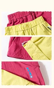 Detail view of pink and yellow wide-leg pants with elastic waist and adjustable drawcord
