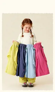 Detailed view of colorful kids' cargo pants with side pockets and letter embroidery