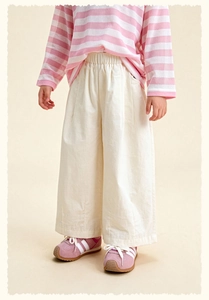 Detail view of pink striped long sleeve tee and cream white wide leg trousers for kids
