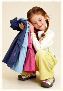 Detailed view of elastic waistbands and side letter prints on kids' colorful casual pants