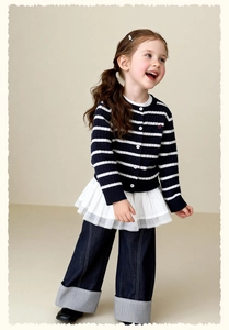 Detail of girls striped cardigan with lace hem and wide-leg jeans with striped cuffs
