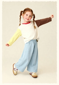 Detailed shot of kids color-block long sleeve tee and light blue wide-leg casual pants