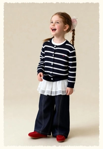 Detail of girls' navy striped knit cardigan with red 'a' embroidery and mesh tulle hem