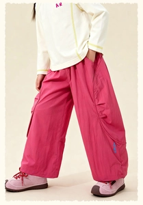 Detailed view of kids' off-white lettered top and bright pink wide-leg cargo pants