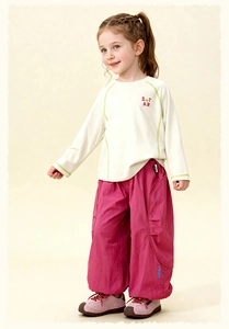 Detail of girls cotton set with white letter t-shirt and pink wide leg trousers