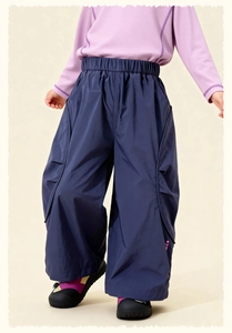 Detail of kids navy cargo pants with elastic waist and oversized side pleated pockets