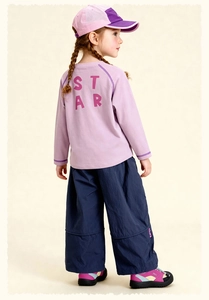 Detail view of the STAR logo on kids' casual lavender long-sleeved t-shirt and navy pants
