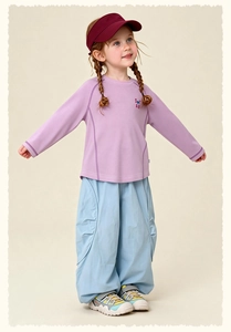Detail of kids purple sweatshirt with STAR print and blue elastic hem trousers