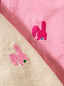 Detailed embroidery of cartoon bunny on pink and white woven cotton leisure pants for kids