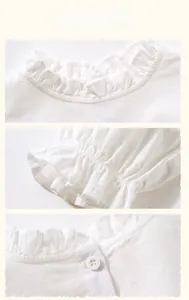 Detailed view of white cotton-linen girl's dress featuring ruffled edges and vintage buttons