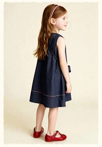Detail of dark blue sleeveless denim dress for girls with colorful stripes on the hem